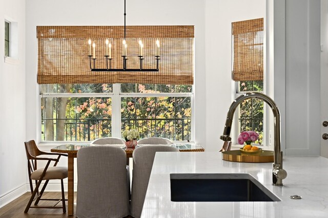 dining space featuring an inviting chandelier and sink