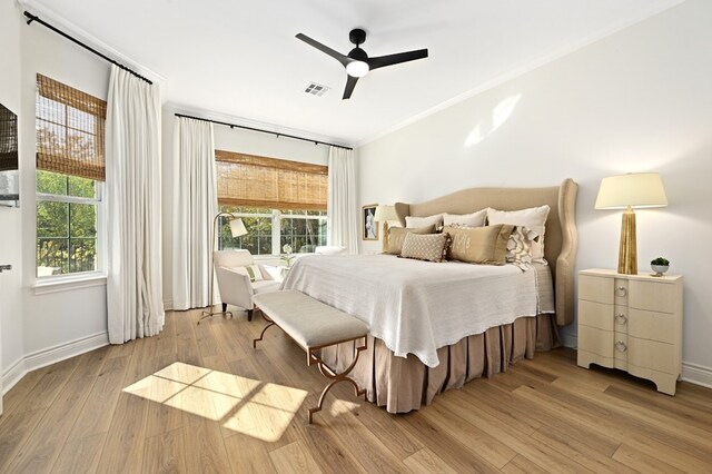 bedroom featuring crown molding, ceiling fan, and light wood-type flooring