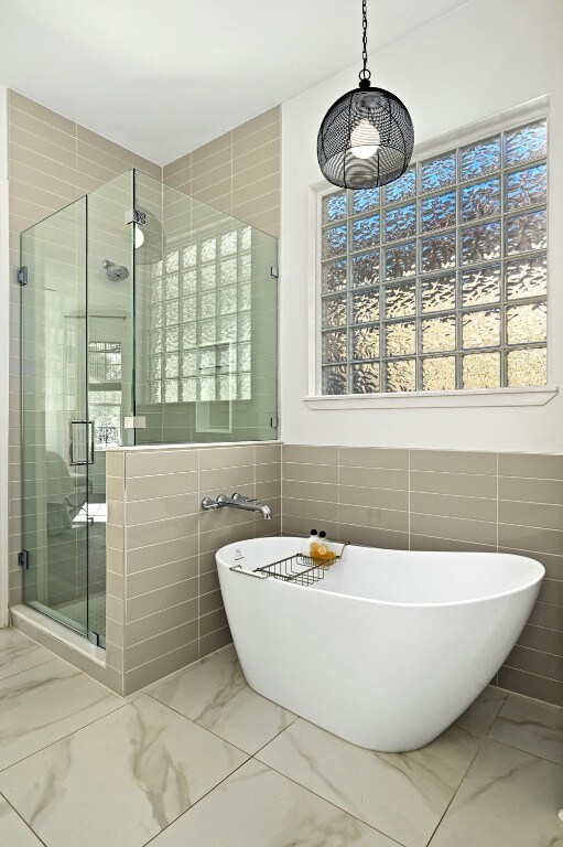 bathroom with shower with separate bathtub