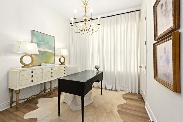 office area with an inviting chandelier and wood-type flooring