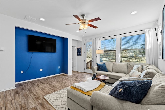 living room featuring hardwood / wood-style flooring and ceiling fan