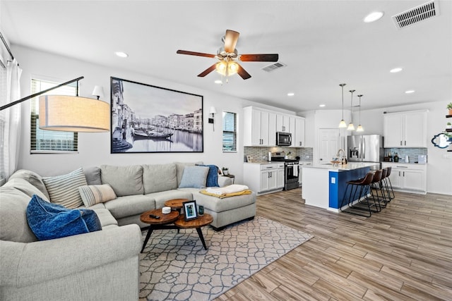 2004 Tasmanian Tiger Trce, Austin, TX 78728 - living area featuring a ceiling fan, recessed lighting, and light wood finished floors