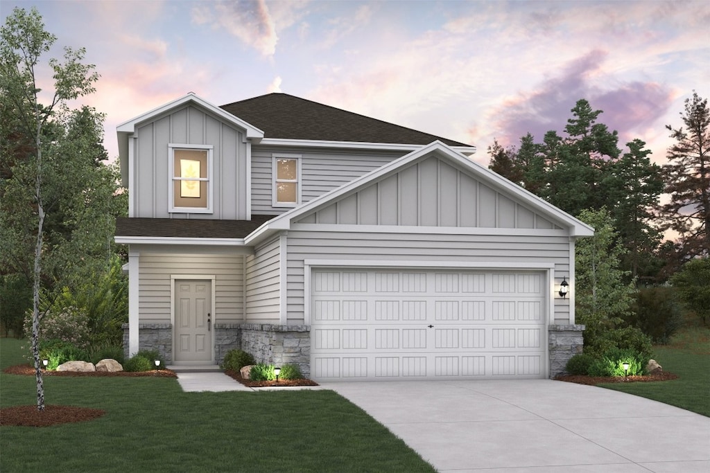 view of front of house featuring a garage and a yard