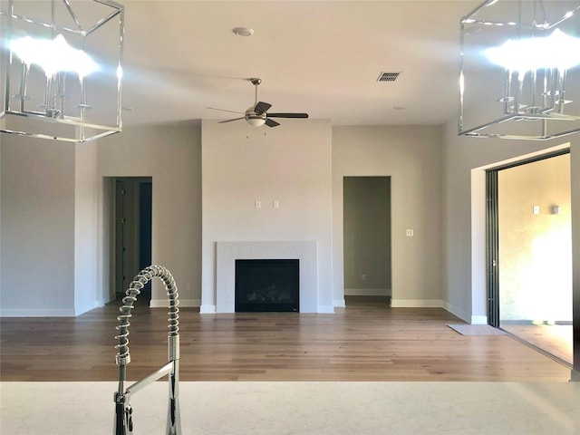 unfurnished living room featuring ceiling fan and wood-type flooring