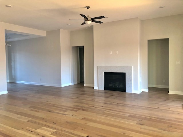 unfurnished living room featuring hardwood / wood-style floors and ceiling fan