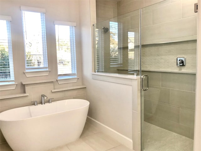 bathroom featuring tile patterned floors and shower with separate bathtub