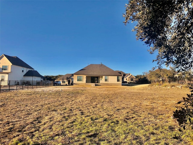 rear view of house with a lawn