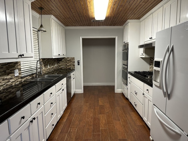 kitchen with pendant lighting, sink, white cabinets, stainless steel appliances, and wooden ceiling