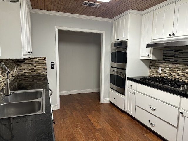 kitchen with stainless steel appliances, sink, decorative backsplash, and white cabinets