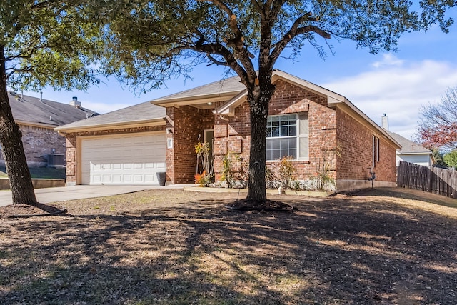 ranch-style home with central AC unit and a garage