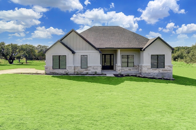 rear view of property with french doors and a lawn