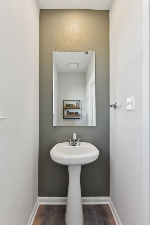 bathroom with hardwood / wood-style flooring