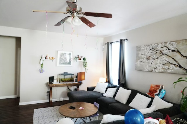 living room featuring ceiling fan and dark hardwood / wood-style flooring