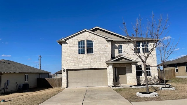 front of property with a garage and central air condition unit