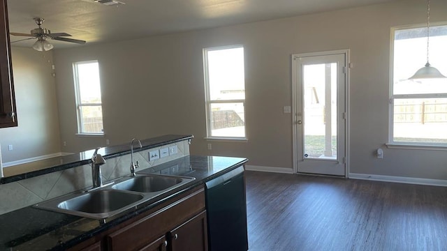 kitchen with pendant lighting, sink, dark hardwood / wood-style floors, black dishwasher, and a wealth of natural light