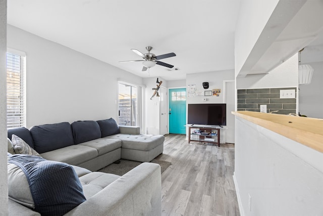 living room with ceiling fan, a healthy amount of sunlight, and light hardwood / wood-style flooring