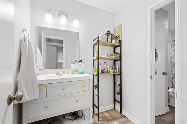 bathroom with vanity, hardwood / wood-style floors, a shower with curtain, and toilet