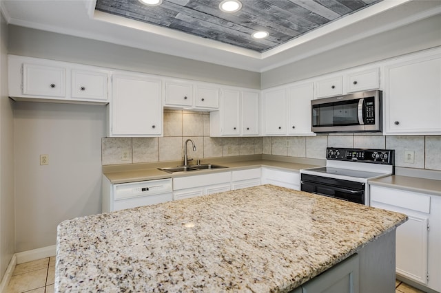 kitchen featuring sink, white cabinetry, electric range, white dishwasher, and a tray ceiling