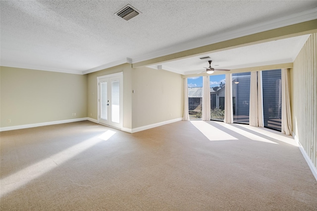 unfurnished room featuring ceiling fan, carpet floors, ornamental molding, a textured ceiling, and french doors