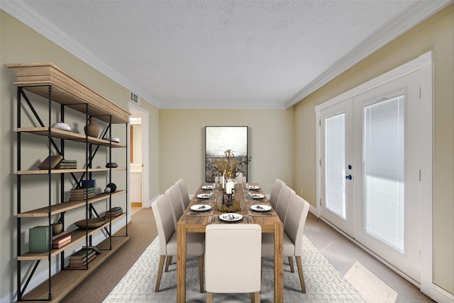 carpeted dining space featuring french doors, crown molding, and a textured ceiling