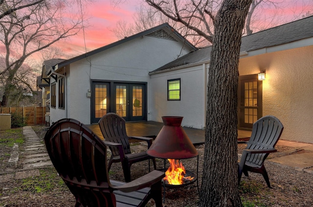 back house at dusk featuring a fire pit