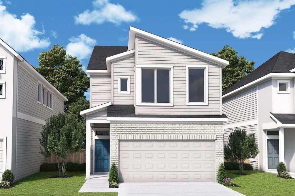 view of front of home featuring a garage and a front lawn