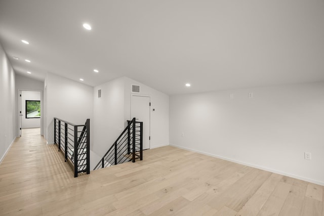 interior space featuring vaulted ceiling and light wood-type flooring