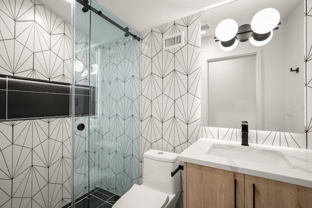 bathroom with vanity, an enclosed shower, tile walls, and toilet