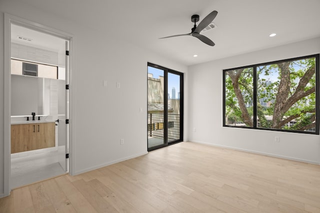 unfurnished room featuring ceiling fan and light hardwood / wood-style flooring