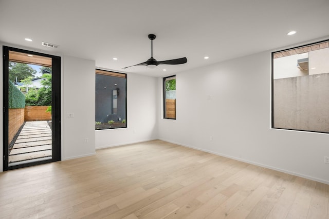 unfurnished room with ceiling fan and light hardwood / wood-style floors