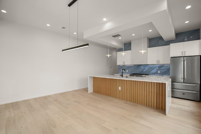 kitchen with white cabinetry, a spacious island, high end refrigerator, and hanging light fixtures