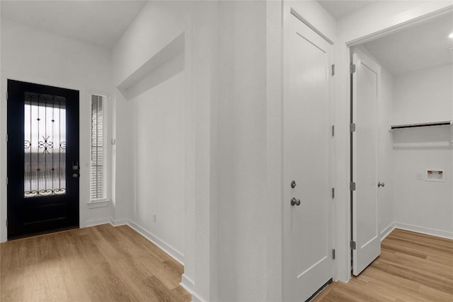 entrance foyer with light wood-style floors and baseboards