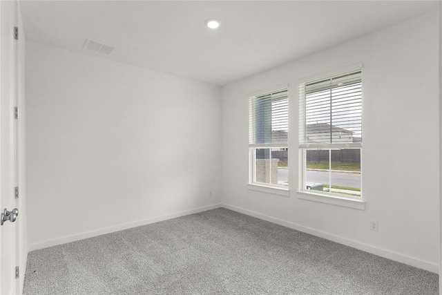 unfurnished room featuring recessed lighting, carpet floors, visible vents, and baseboards