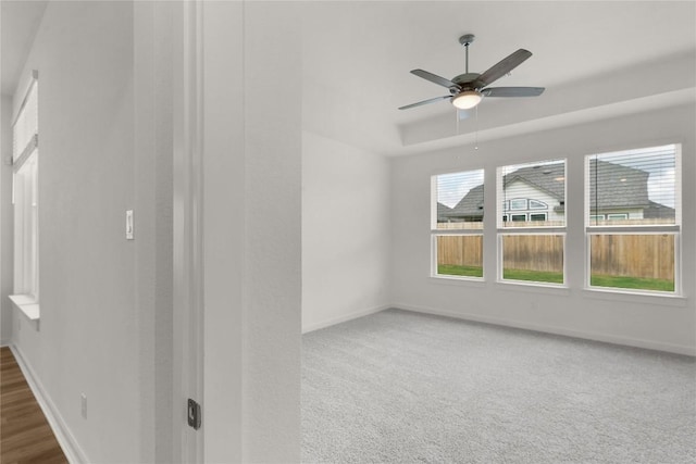 unfurnished room with baseboards, a ceiling fan, and carpet flooring