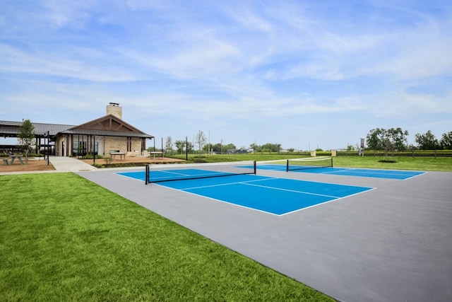 view of tennis court featuring a gazebo and a yard
