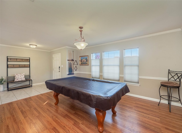 rec room with ornamental molding and light wood-type flooring