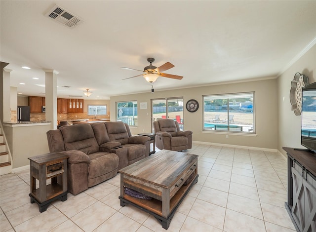 tiled living room with crown molding and ceiling fan