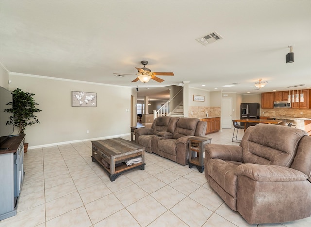 living room featuring crown molding, ceiling fan, and light tile patterned flooring