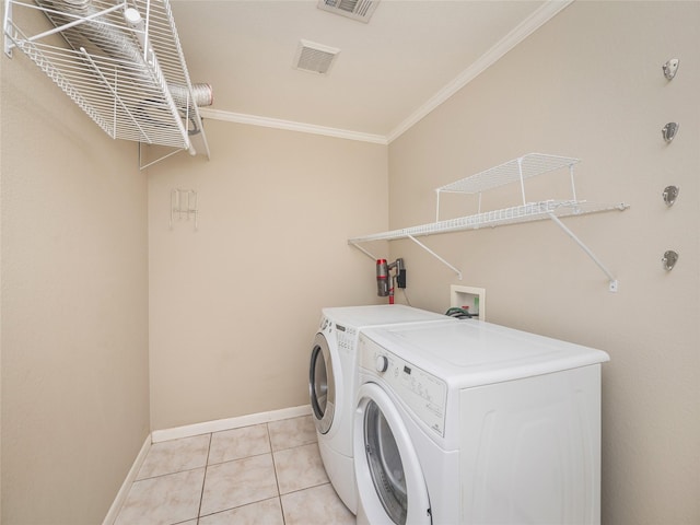 clothes washing area with crown molding, light tile patterned floors, and independent washer and dryer