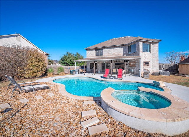 view of pool with an in ground hot tub, a grill, and a patio