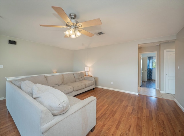 living room featuring hardwood / wood-style floors and ceiling fan