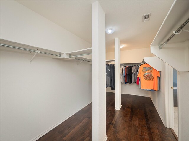 walk in closet featuring dark hardwood / wood-style flooring