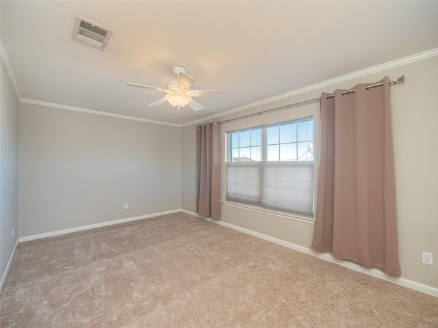 empty room featuring crown molding, light carpet, and ceiling fan