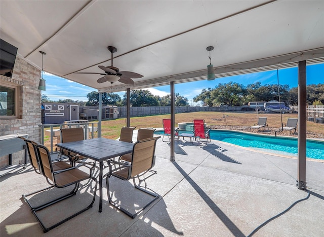 view of patio featuring a fenced in pool and ceiling fan