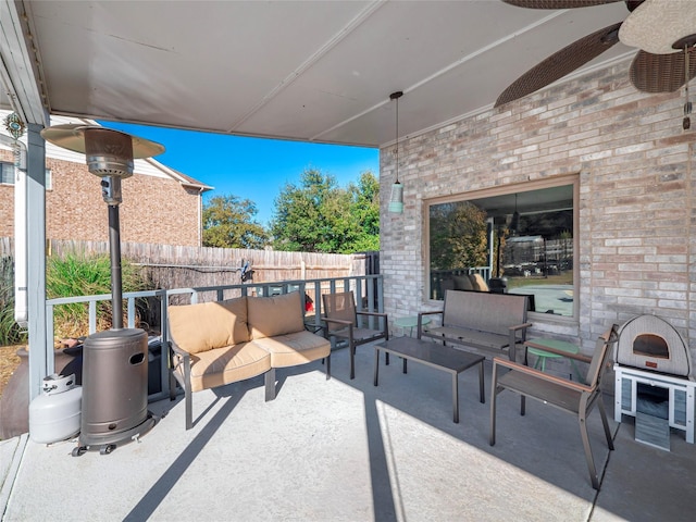 view of patio with an outdoor living space and ceiling fan