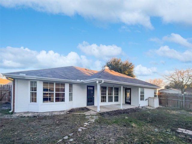 2005 Lark Ln, Taylor, TX 76574 - back of house with a patio and a chimney