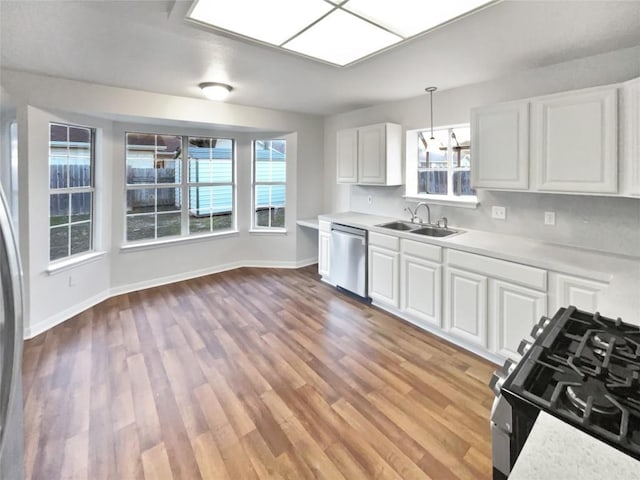 2005 Lark Ln, Taylor, TX 76574 - kitchen featuring stainless steel dishwasher, light countertops, and plenty of natural light
