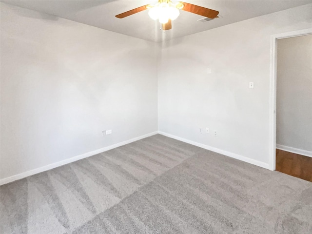 carpeted spare room featuring ceiling fan