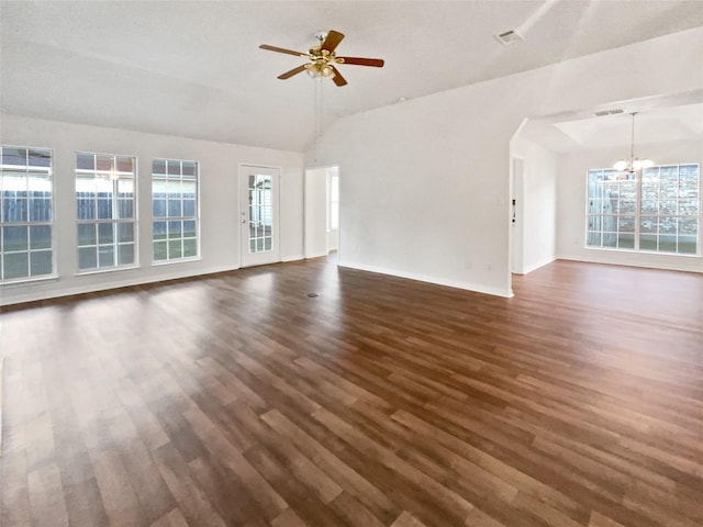 unfurnished living room featuring plenty of natural light, dark hardwood / wood-style floors, and ceiling fan with notable chandelier