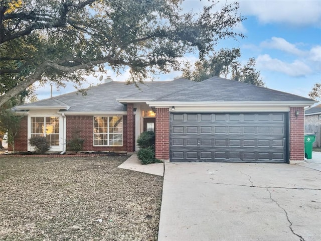 2005 Lark Ln, Taylor, TX 76574 - ranch-style home featuring brick siding, a garage, and concrete driveway